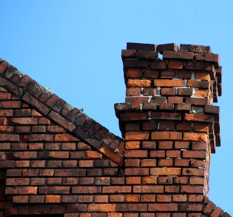 Signs Your Gaithersburg Home Needs a Chimney Inspection Damaged chimney on an Gaithersburg home showing cracks and missing mortar